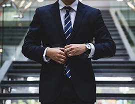 person poitioning his tie